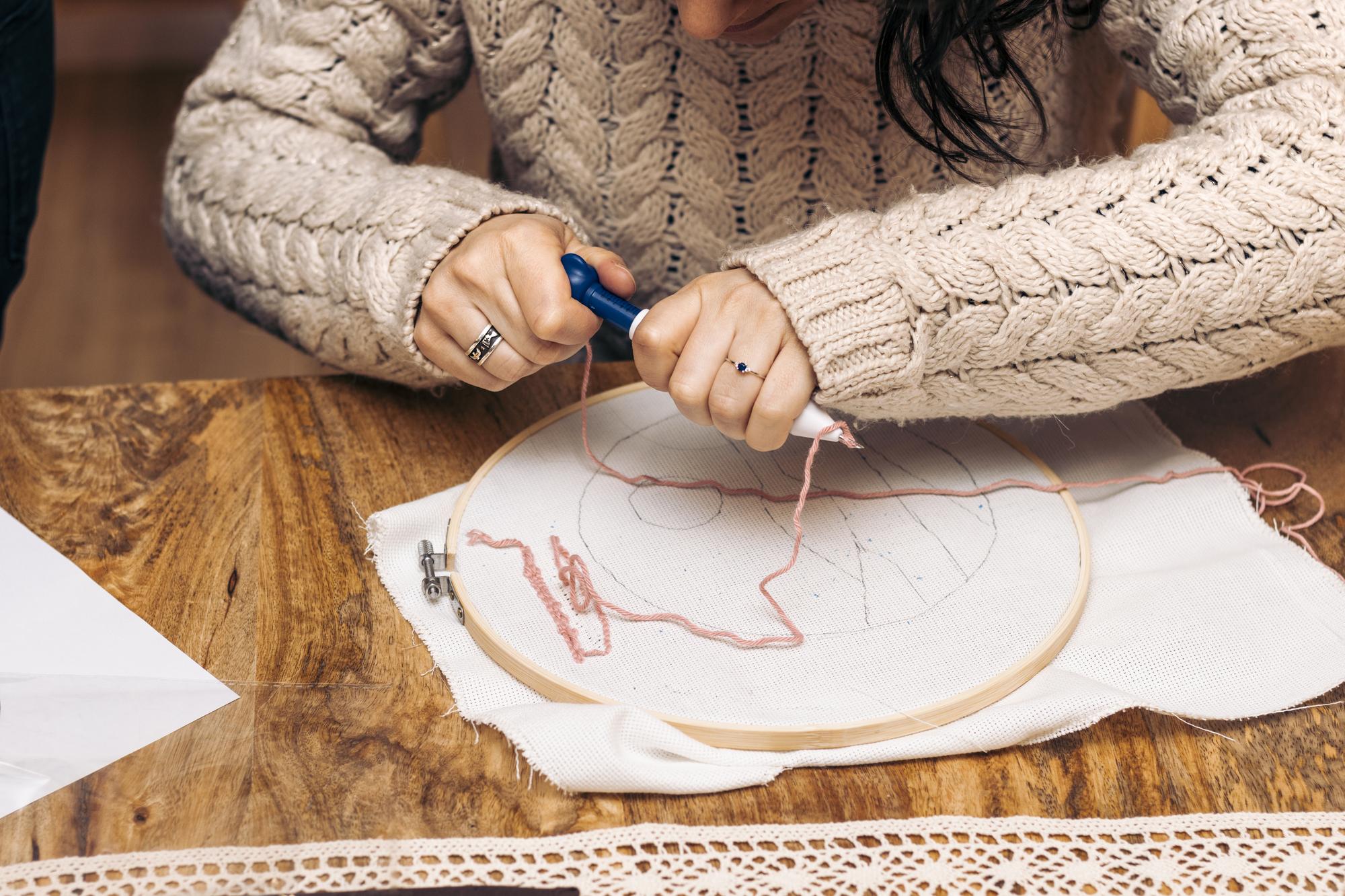 Close-up of hand embroidery on linen, detailed stitches